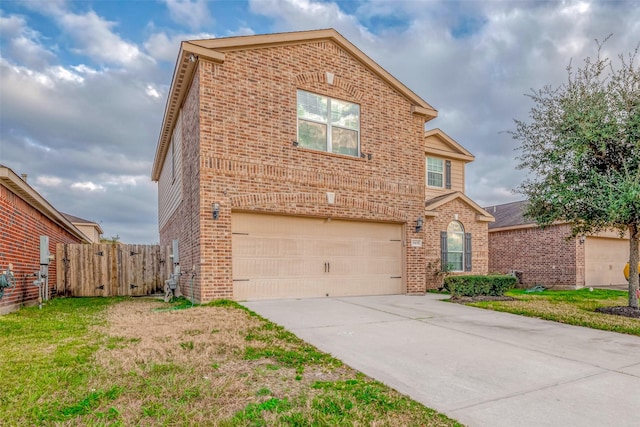 traditional-style house with brick siding, an attached garage, a gate, fence, and driveway