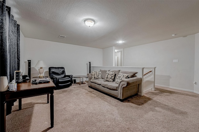 living room with light colored carpet, visible vents, a textured ceiling, and baseboards