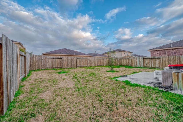 view of yard with a fenced backyard and a patio