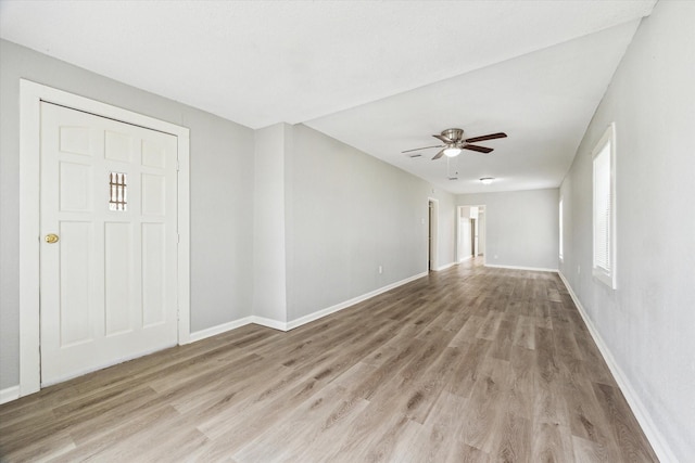 interior space with light wood-style floors, ceiling fan, and baseboards