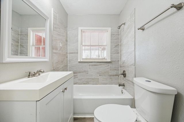 bathroom with shower / washtub combination, plenty of natural light, vanity, and toilet