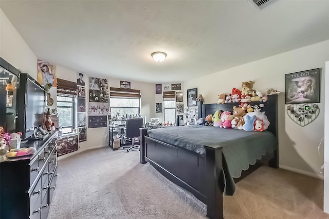 bedroom with baseboards, visible vents, and light colored carpet