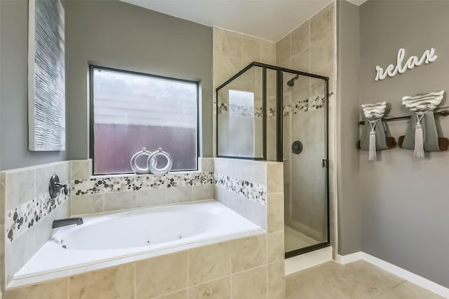 bathroom featuring a stall shower, tile patterned flooring, and a garden tub