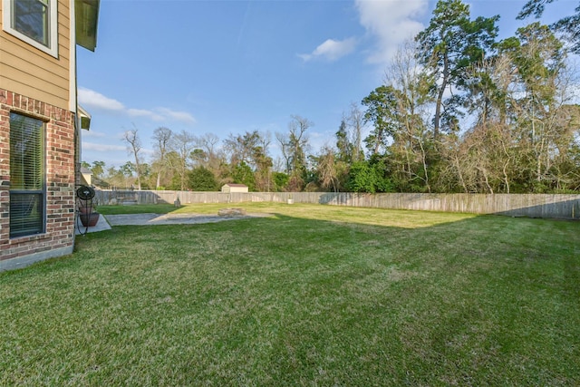 view of yard with a fenced backyard and a patio