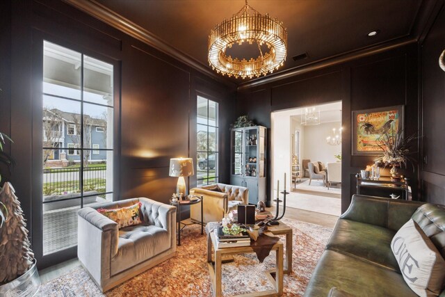 living area featuring an inviting chandelier, visible vents, a decorative wall, and crown molding