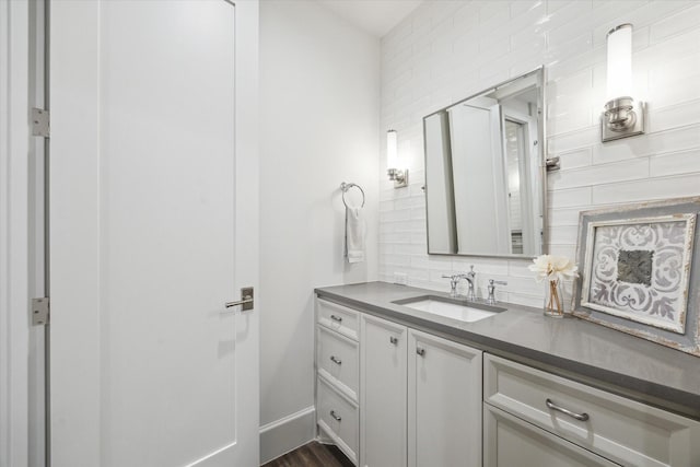 bathroom featuring backsplash, vanity, and wood finished floors