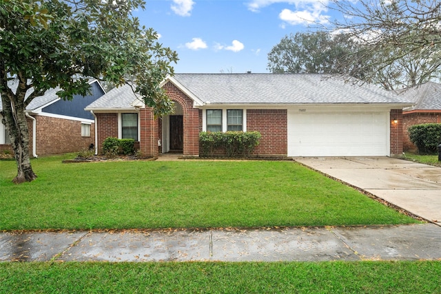 ranch-style home with a garage, driveway, a front lawn, and brick siding