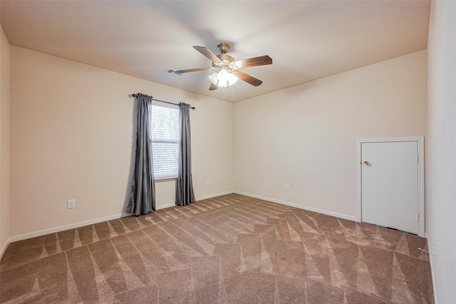 spare room featuring carpet flooring, baseboards, and ceiling fan