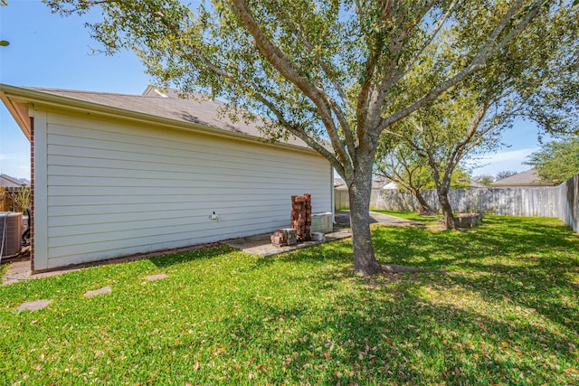 view of yard featuring central AC and a fenced backyard