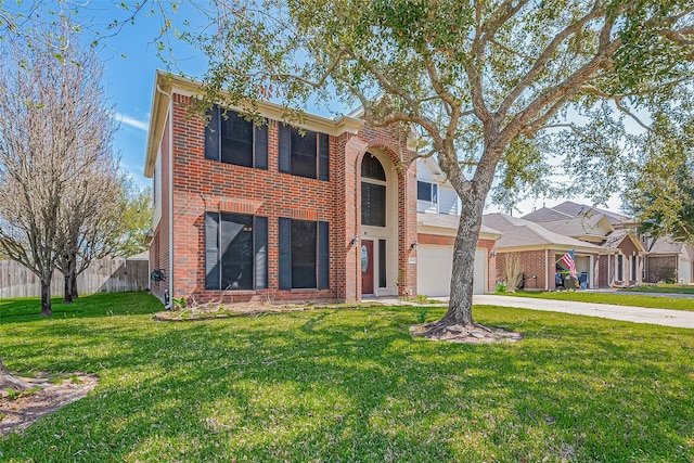 view of front facade featuring a front yard, fence, driveway, an attached garage, and brick siding