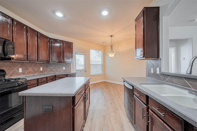 kitchen with baseboards, a sink, black appliances, light wood-style floors, and backsplash