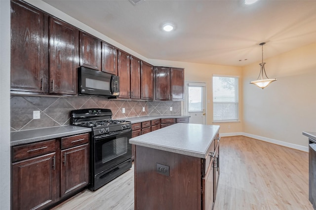 kitchen featuring tasteful backsplash, baseboards, black appliances, and light wood-style floors