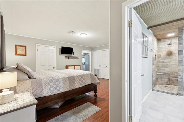 bedroom with light wood-type flooring and crown molding