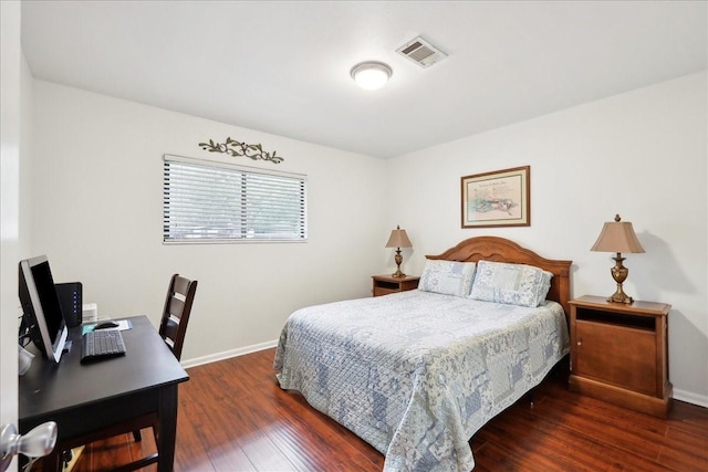 bedroom featuring dark wood-style floors, baseboards, and visible vents