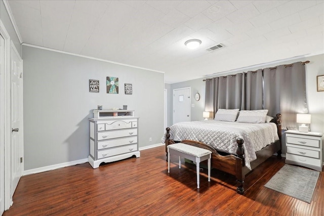 bedroom with baseboards, crown molding, visible vents, and dark wood-type flooring