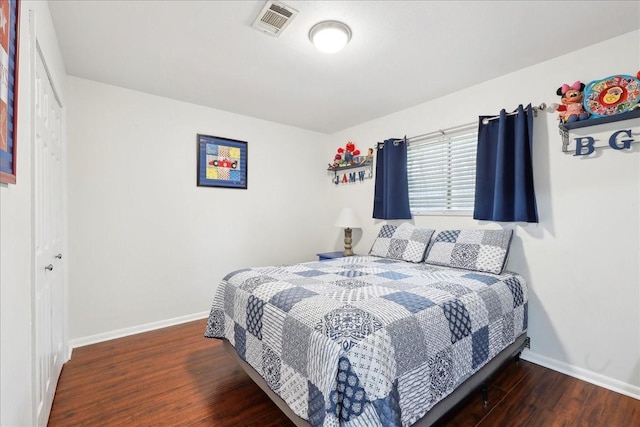 bedroom with baseboards, visible vents, and dark wood-style flooring