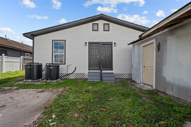 entrance to property with fence and central air condition unit