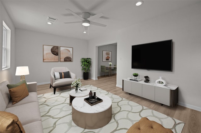 living area featuring light wood-style floors, recessed lighting, visible vents, and baseboards