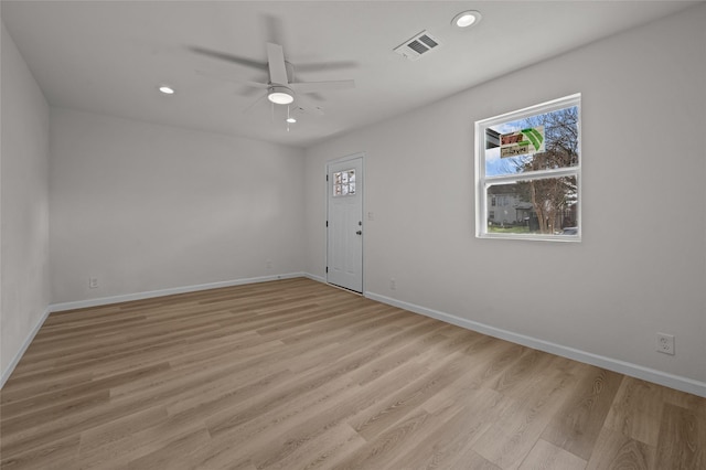 unfurnished room with light wood finished floors, visible vents, and recessed lighting