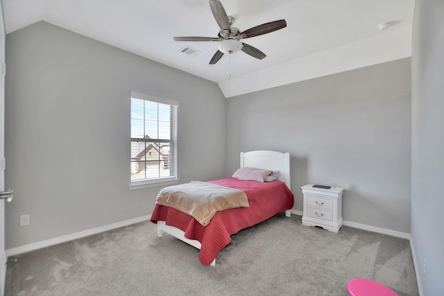 carpeted bedroom with lofted ceiling, baseboards, visible vents, and ceiling fan