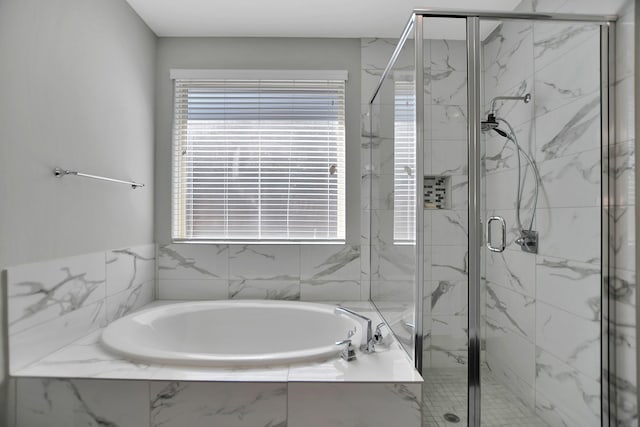 full bath with a garden tub and a marble finish shower