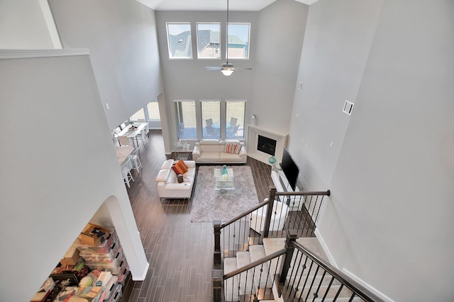 living area with a wealth of natural light, a fireplace, wood finished floors, and visible vents