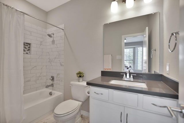 bathroom featuring toilet, a ceiling fan, vanity, and shower / bathtub combination with curtain