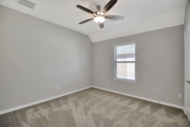 unfurnished room featuring baseboards, visible vents, light colored carpet, ceiling fan, and vaulted ceiling