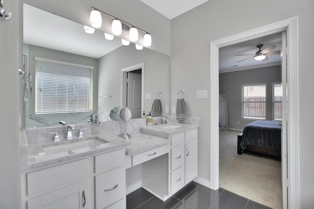 ensuite bathroom with ensuite bathroom, double vanity, ceiling fan, and a sink