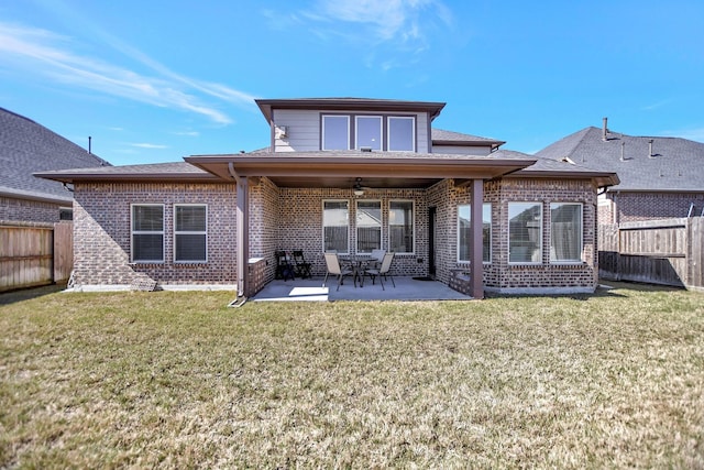 rear view of house with a patio, brick siding, fence private yard, and a ceiling fan