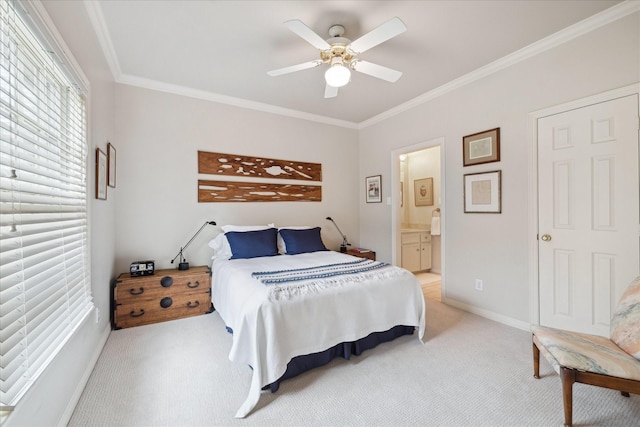 bedroom featuring light carpet, a ceiling fan, baseboards, ensuite bath, and crown molding