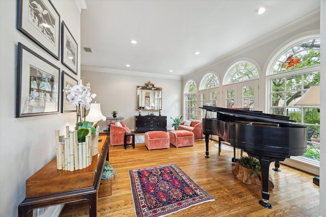 sitting room with light wood-type flooring, recessed lighting, visible vents, and ornamental molding