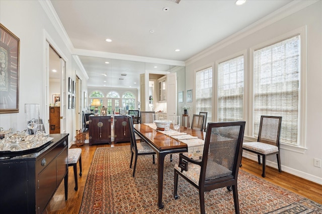 dining area featuring baseboards, ornamental molding, wood finished floors, and recessed lighting