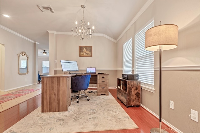 home office featuring ornamental molding, light wood-type flooring, visible vents, and baseboards