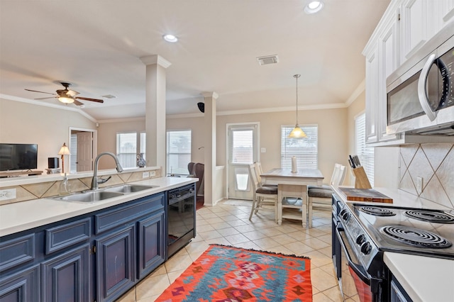 kitchen with black dishwasher, light countertops, stainless steel microwave, visible vents, and a sink