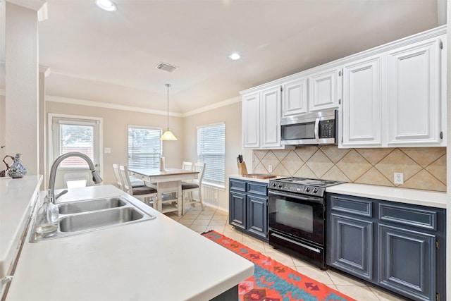 kitchen featuring light countertops, black / electric stove, stainless steel microwave, and white cabinets