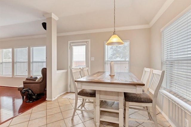 dining space featuring baseboards, light tile patterned floors, and crown molding