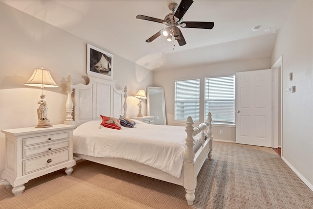 bedroom with baseboards, vaulted ceiling, and a ceiling fan