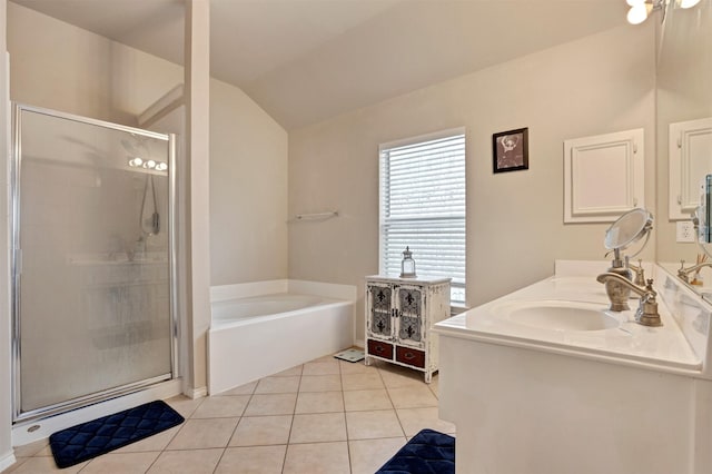 bathroom with tile patterned floors, a sink, vaulted ceiling, a shower stall, and a bath