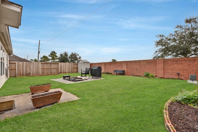 view of yard featuring a fenced backyard, an outdoor structure, a patio, and a shed