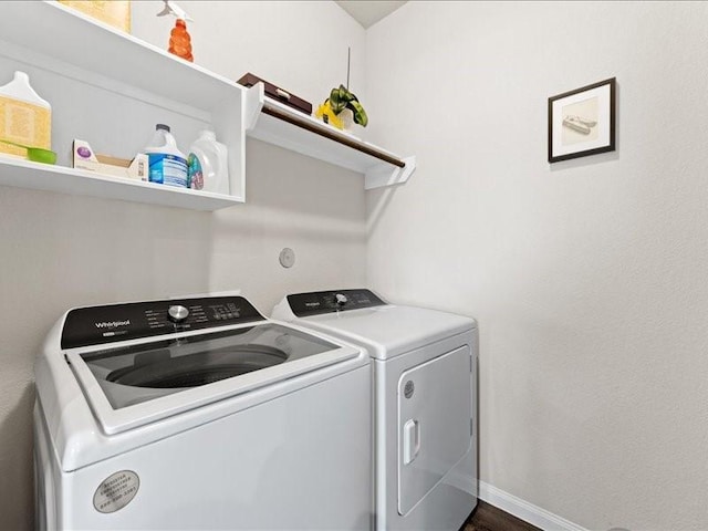 laundry area featuring laundry area, baseboards, and separate washer and dryer