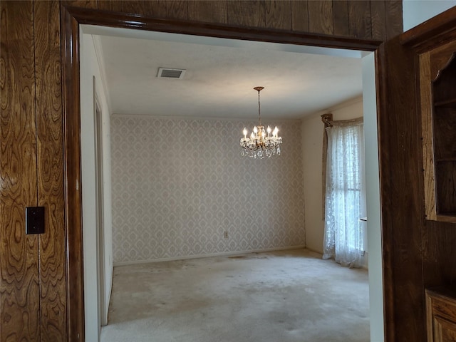 interior space featuring visible vents, an inviting chandelier, ornamental molding, and wallpapered walls