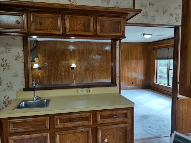 kitchen with wallpapered walls and a sink