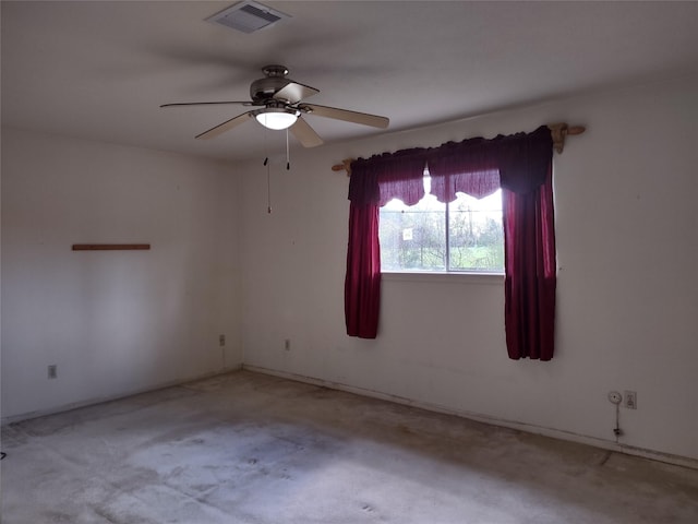 empty room featuring visible vents and ceiling fan