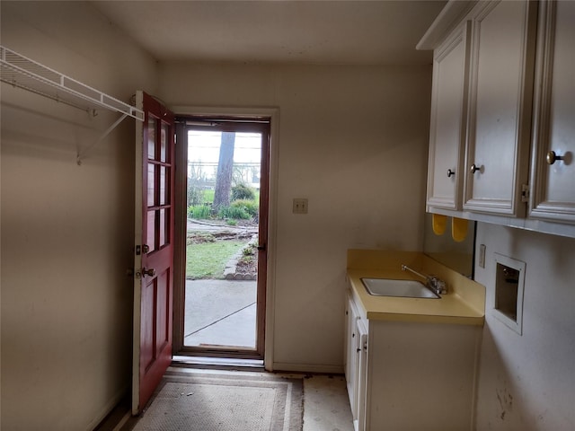 doorway to outside featuring a sink