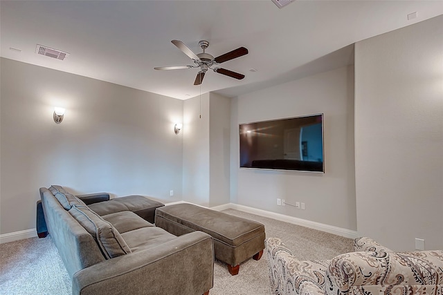 home theater featuring baseboards, visible vents, and light colored carpet