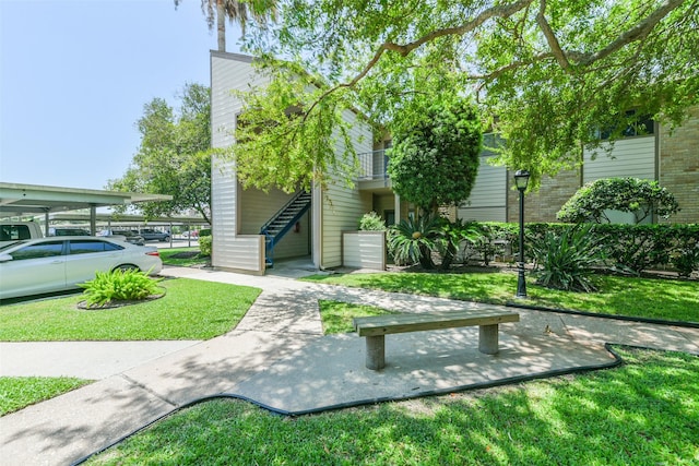 view of home's community featuring a yard and stairway