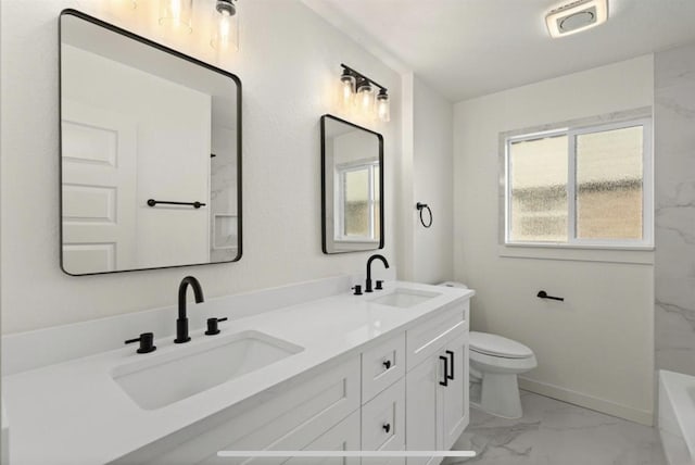 full bathroom with marble finish floor, a sink, toilet, and double vanity