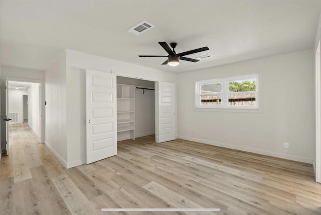 unfurnished bedroom with light wood finished floors, a closet, visible vents, and baseboards