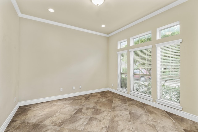 empty room with baseboards, crown molding, and recessed lighting